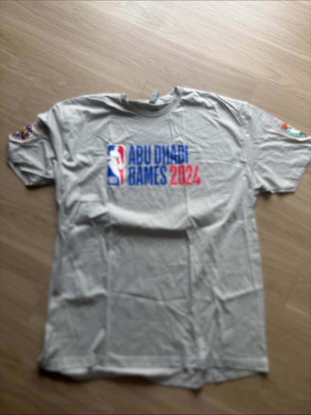 Next Level Apparel Abu Dhabi Games 2024 Tee - Light Gray with Blue & Red Logo XX